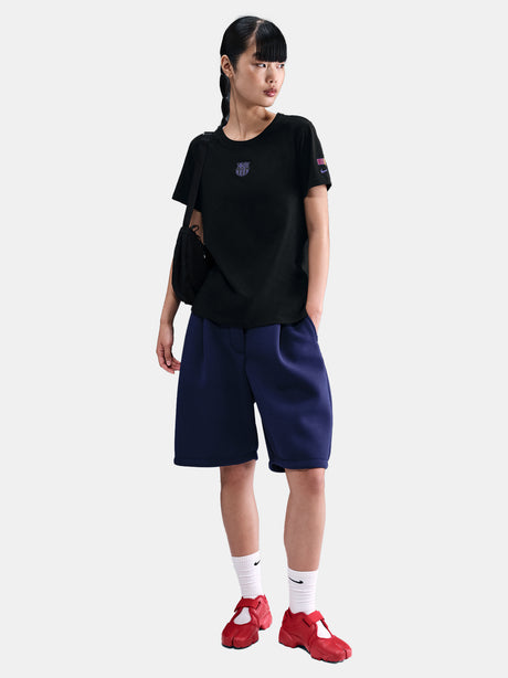 Black FC Barcelona Nike t-shirt with blue Barça crest on the chest, worn casually with blue pants and a black shoulder bag