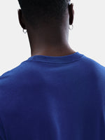 FC Barcelona men's t-shirt in royal blue featuring a minimalist front graphic with the Catalan and club colors, accompanied by the Nike Swoosh and Barça’s “Més que un club” symbol underneath. The design offers a clean and athletic streetwear look, perfect for everyday wear or matchday style.
