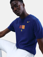 FC Barcelona men's t-shirt in royal blue featuring a minimalist front graphic with the Catalan and club colors, accompanied by the Nike Swoosh and Barça’s “Més que un club” symbol underneath. The design offers a clean and athletic streetwear look, perfect for everyday wear or matchday style.
