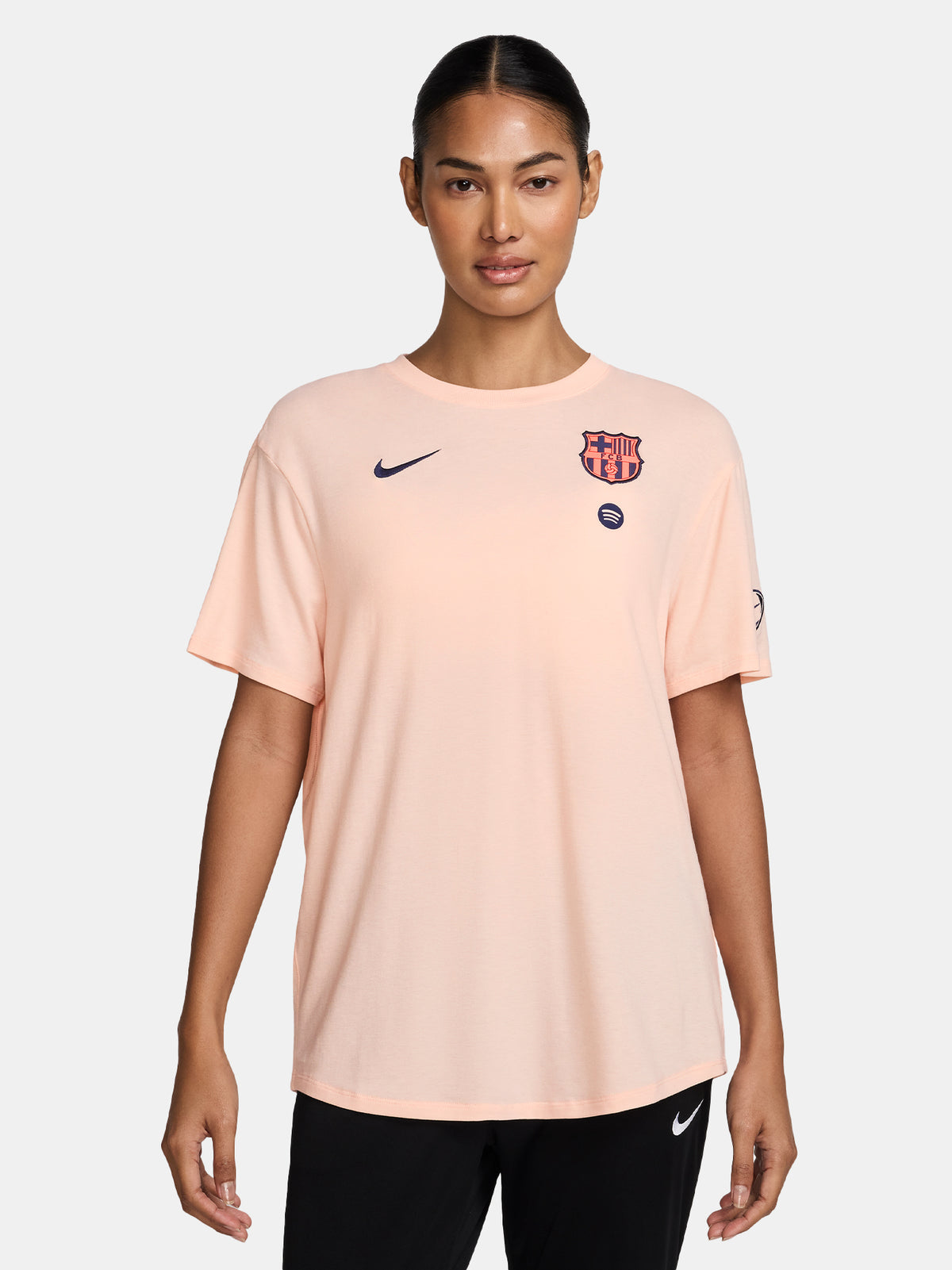 Light peach FC Barcelona Nike women's t-shirt with short sleeves and club crest on the chest.