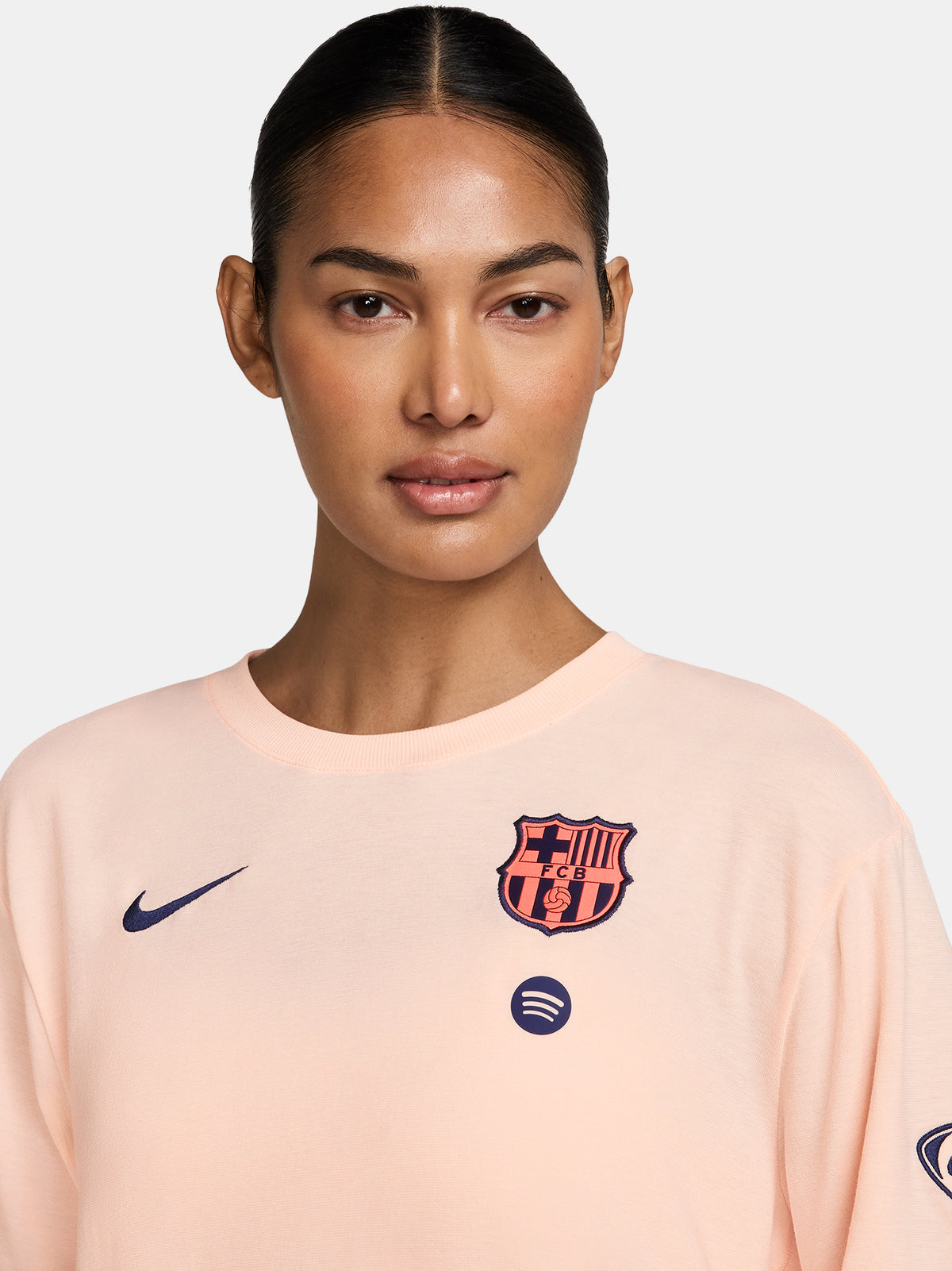 Light peach FC Barcelona Nike women's t-shirt with short sleeves and club crest on the chest.