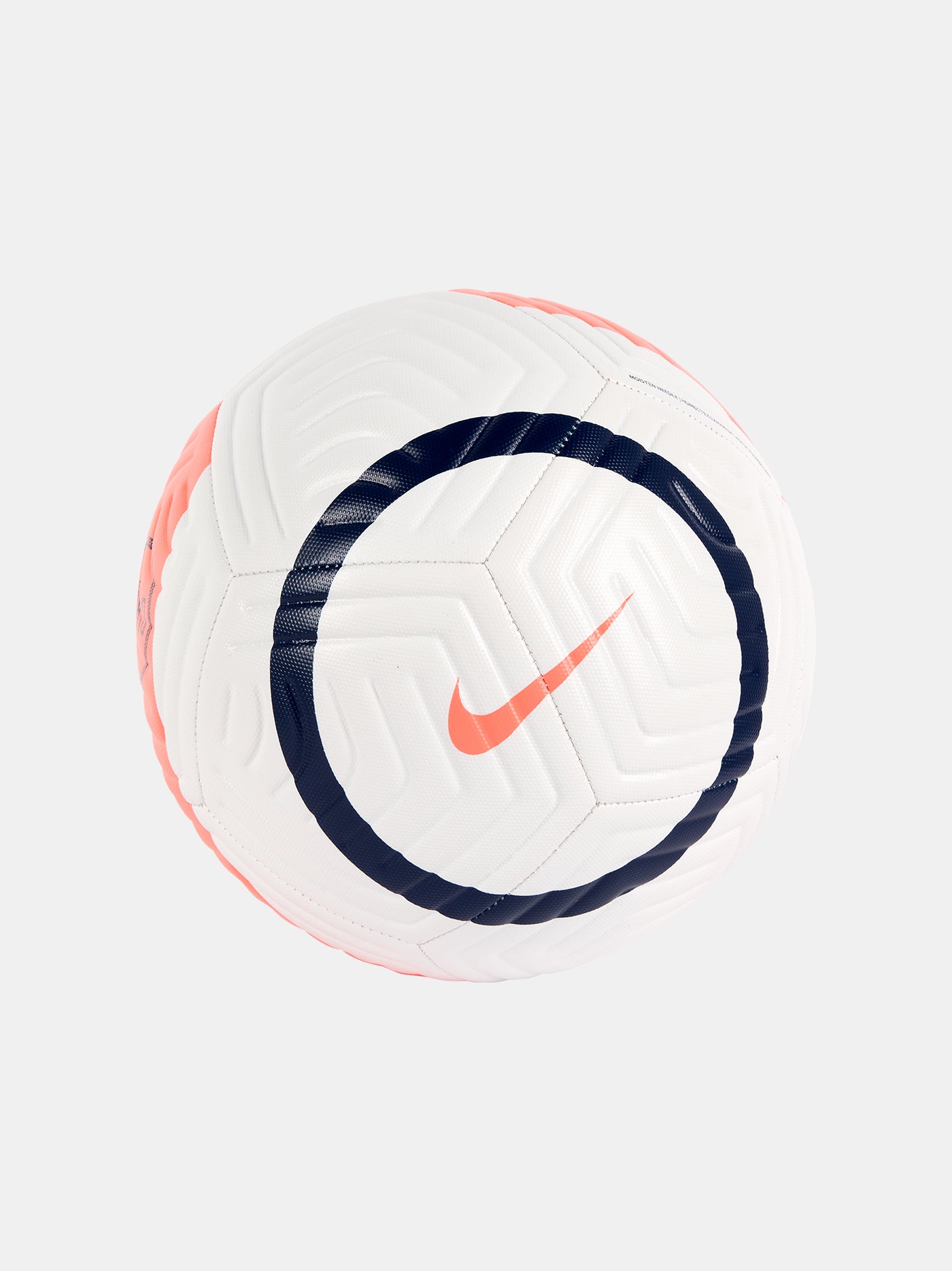 White Nike football with textured panels, navy blue circular design, and coral swoosh logo