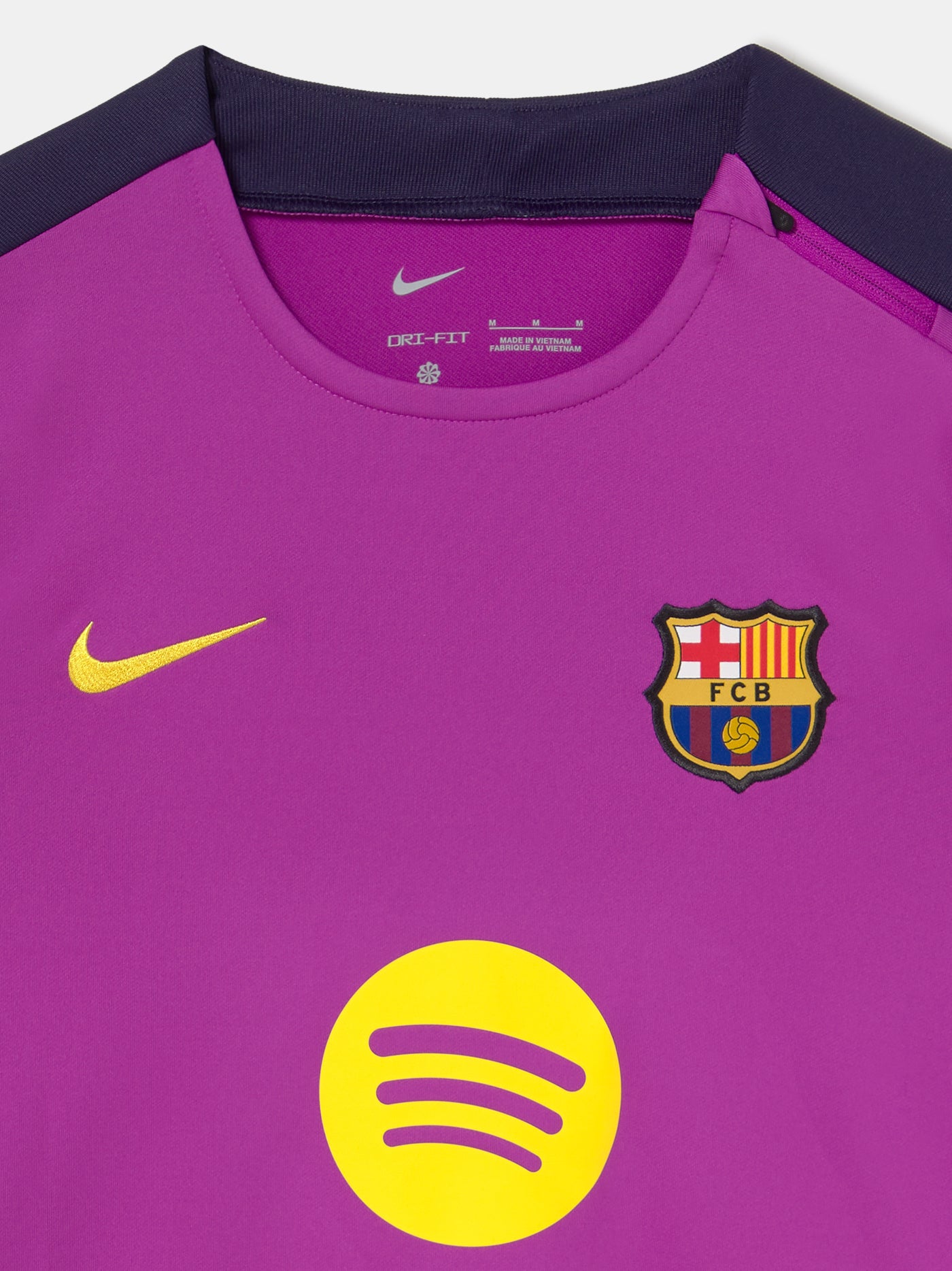 Front view of FC Barcelona 25/26 long-sleeve training top in purple with dark sleeves, featuring Spotify logo, Nike swoosh, and club crest