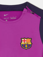 Front view of FC Barcelona 25/26 long-sleeve training top in purple with dark sleeves, featuring Spotify logo, Nike swoosh, and club crest