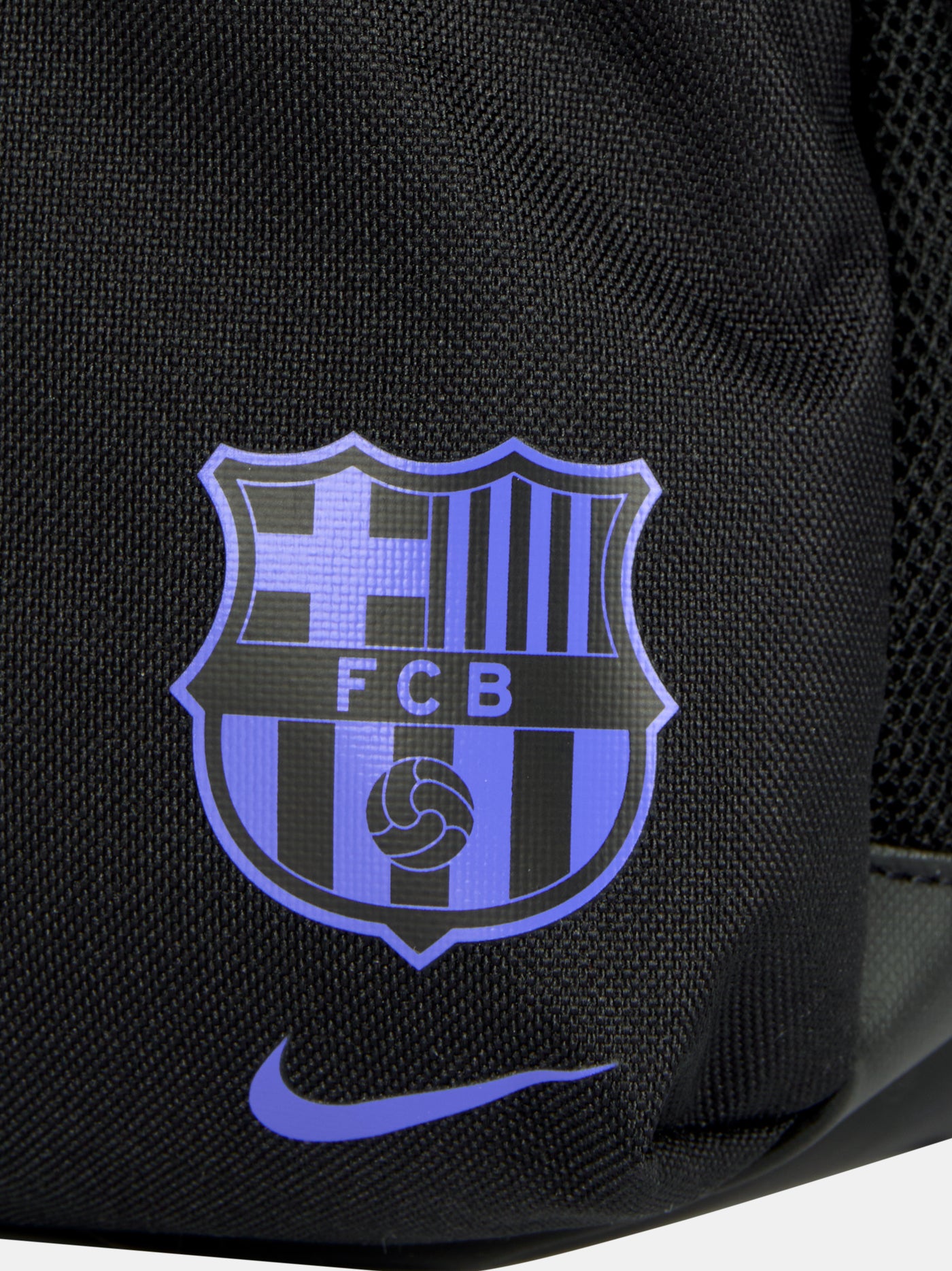 Small black FC Barcelona Nike backpack with textured upper panel, featuring the Kobe Bryant logo in blue on the front, the Barça crest with Nike swoosh in blue on the lower pocket, and a side tag reading 'Just Do It