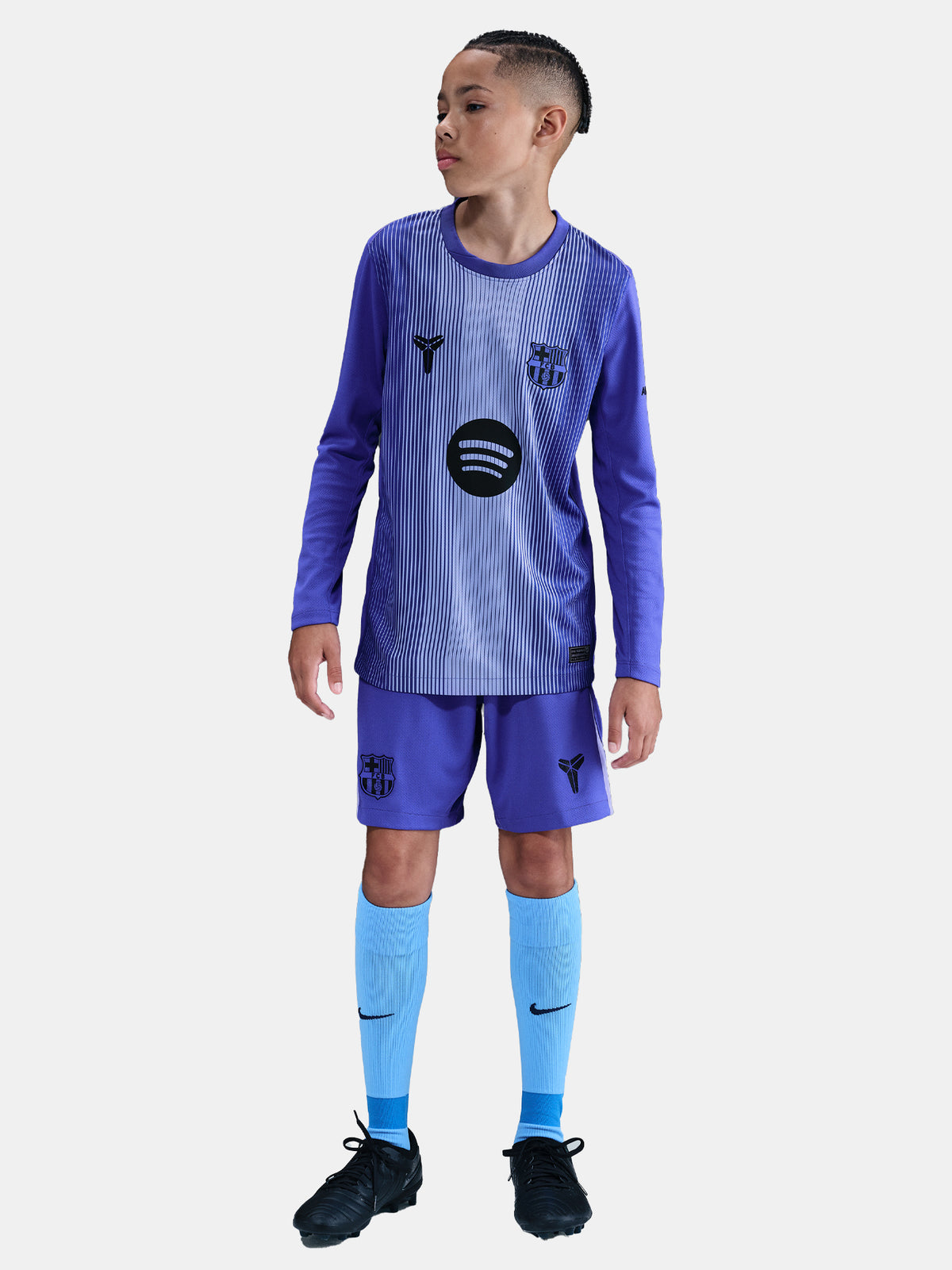 Child wearing a blue sports uniform with a logo on a white background