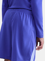 Blue athletic shorts with a white stripe on a white background