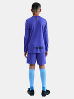 Person wearing a purple sports outfit with visible branding on a white background