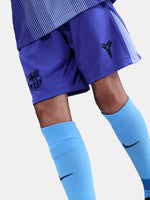 Blue sports shorts and socks with a logo on a light gray background