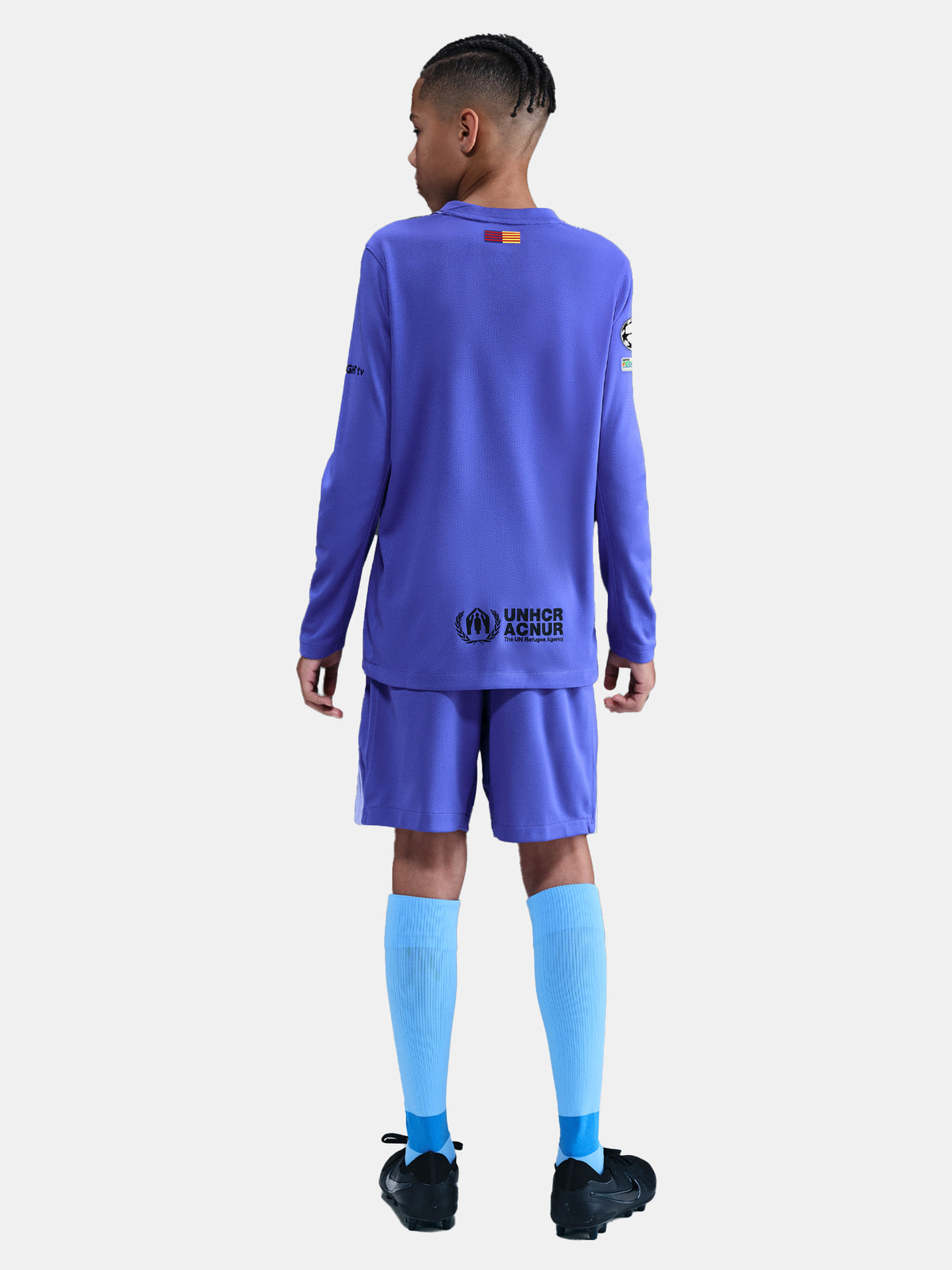 Person wearing a blue sports uniform with visible branding on a white background