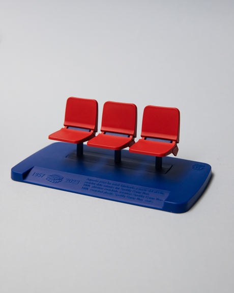 Miniature display of three iconic red Camp Nou stadium seats mounted on a blue base, commemorating the years 1957–2023, marking the historical timeline of FC Barcelona’s legendary stadium.