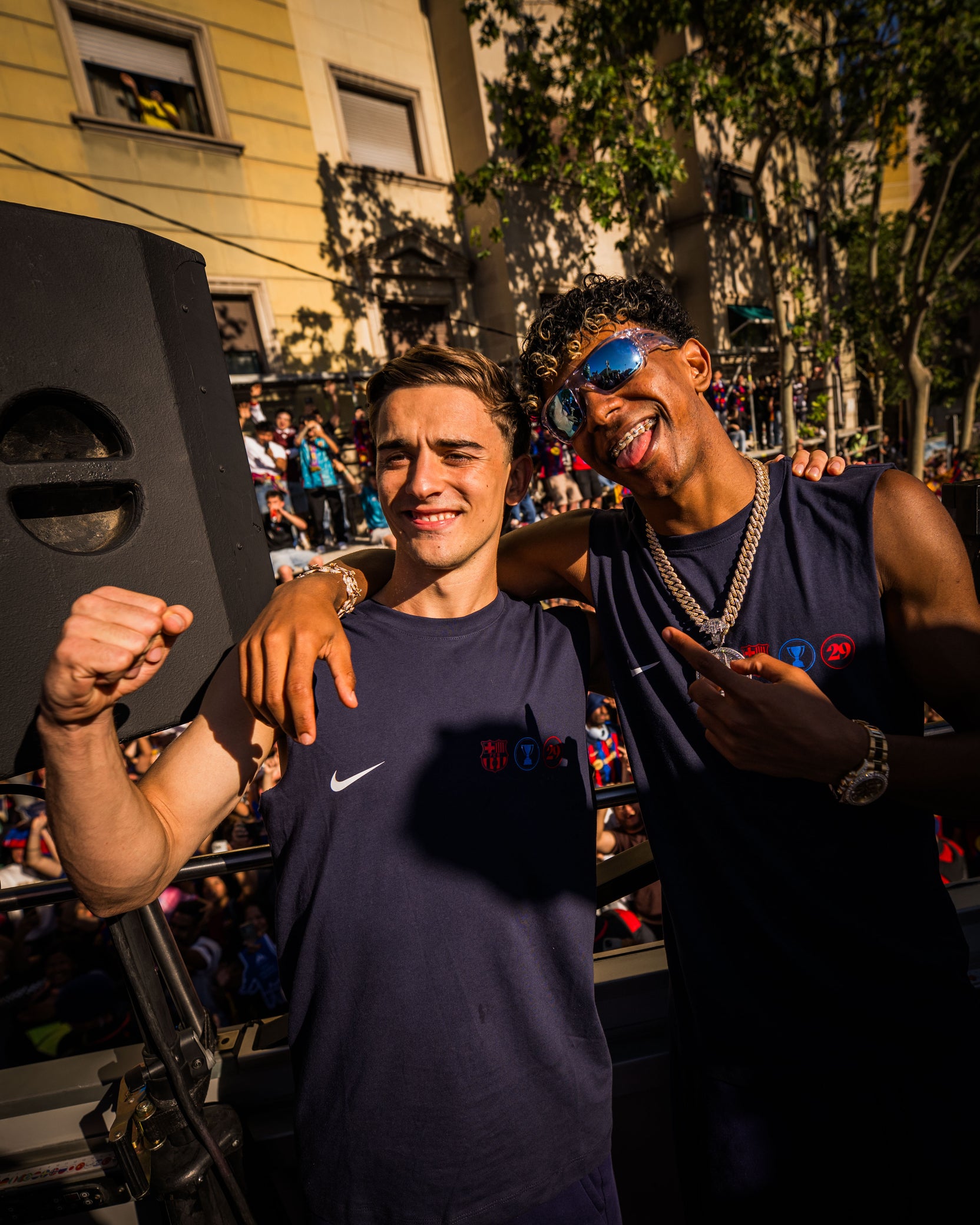 Two people posing together in a festive outdoor setting with music equipment.