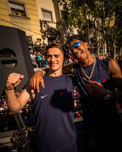 Two people posing together in a festive outdoor setting with music equipment.