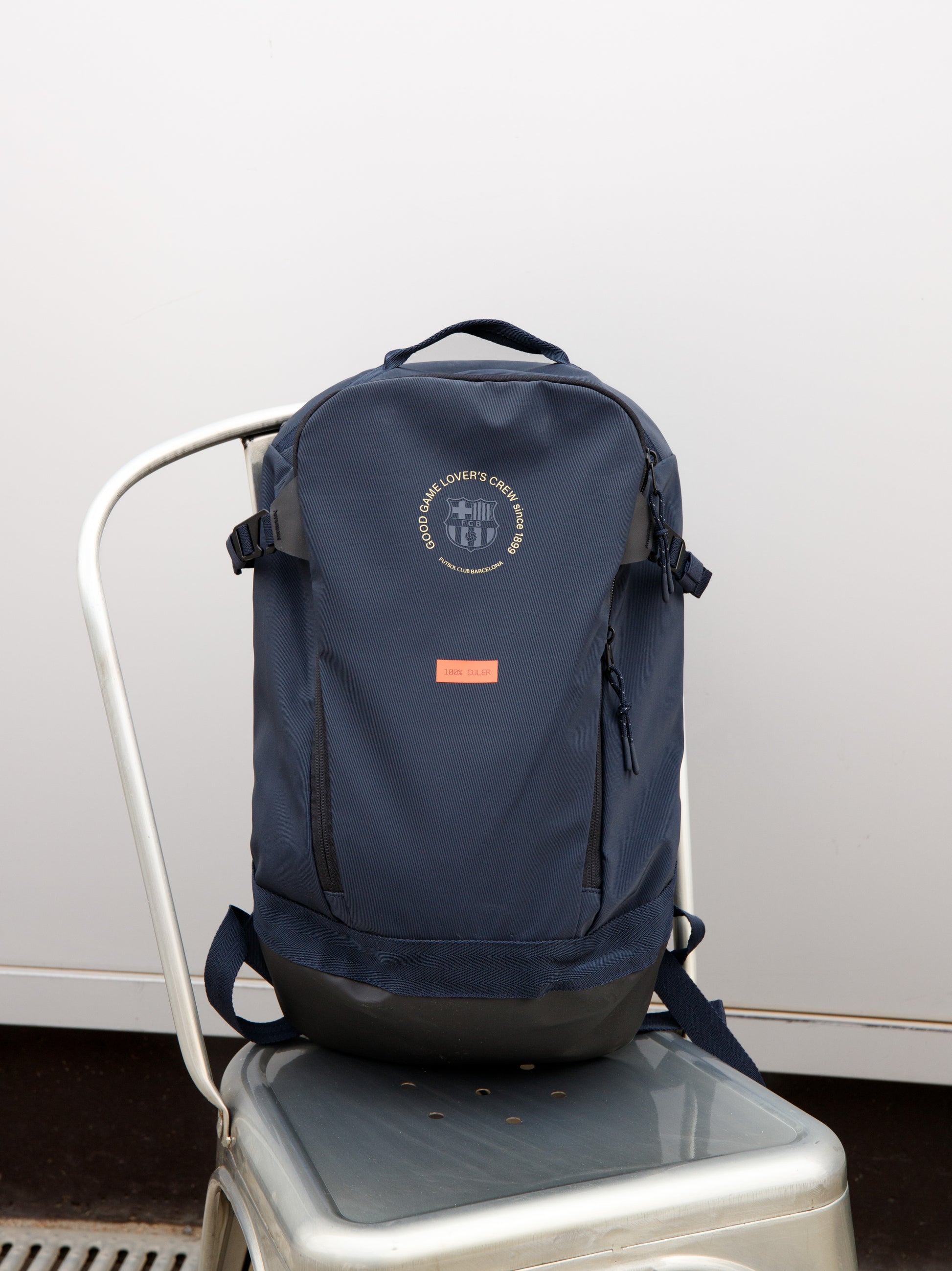 Navy FC Barcelona backpack with embroidered circular crest design, side pocket, and red '1899' patch on the front