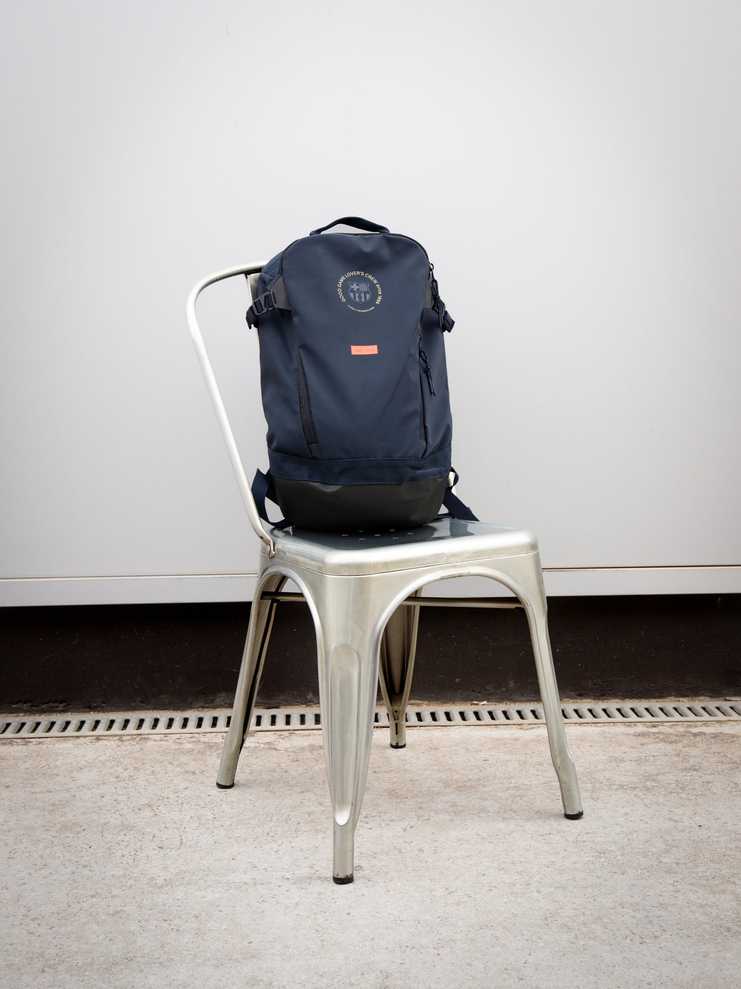 Navy FC Barcelona backpack with embroidered circular crest design, side pocket, and red '1899' patch on the front