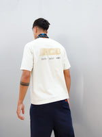 Marc Bernal wearing an off-white FC Barcelona T-shirt with tonal club crest and date detail on the chest, paired with a blue and black patterned neck scarf