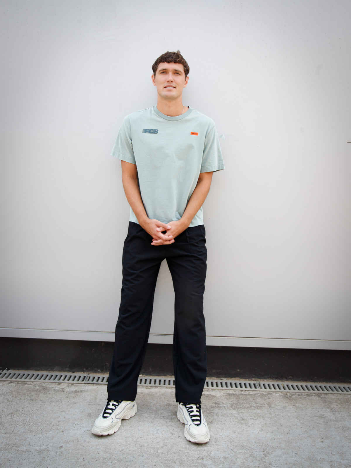 Christensen wearing a light green FC Barcelona T-shirt with tonal crest and 'Good Game Lover’s Crew' graphic print on the back