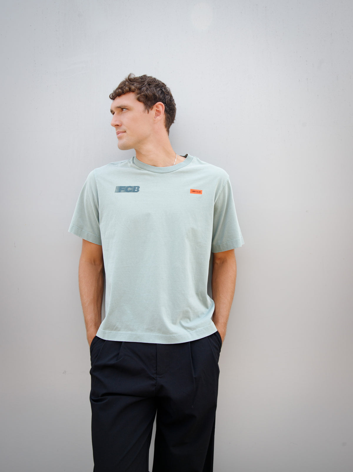 Christensen wearing a light green FC Barcelona T-shirt with tonal crest and 'Good Game Lover’s Crew' graphic print on the back