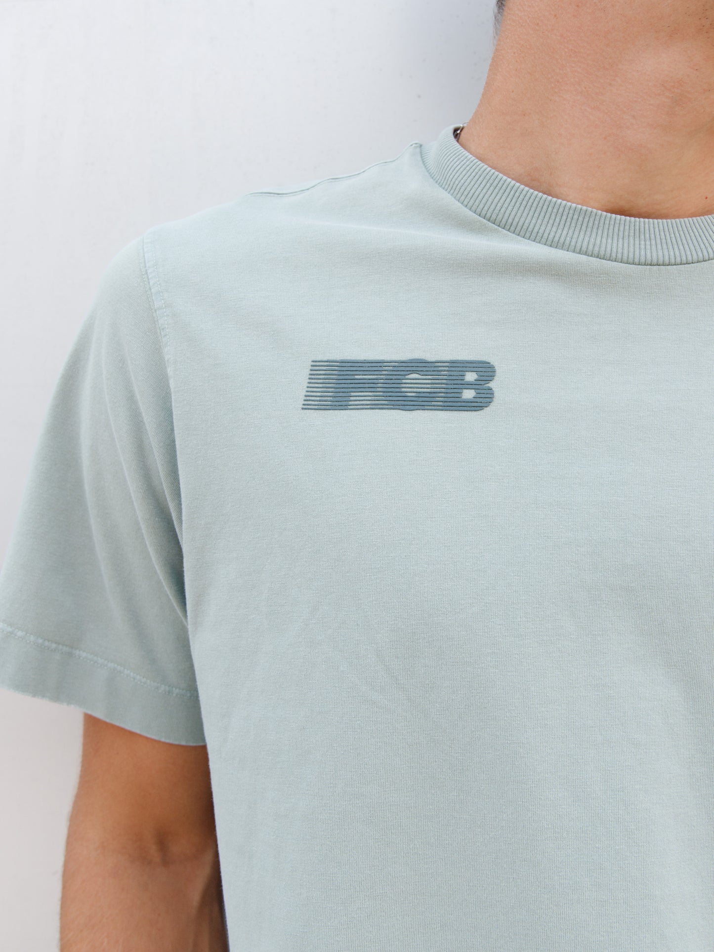 Christensen wearing a light green FC Barcelona T-shirt with tonal crest and 'Good Game Lover’s Crew' graphic print on the back