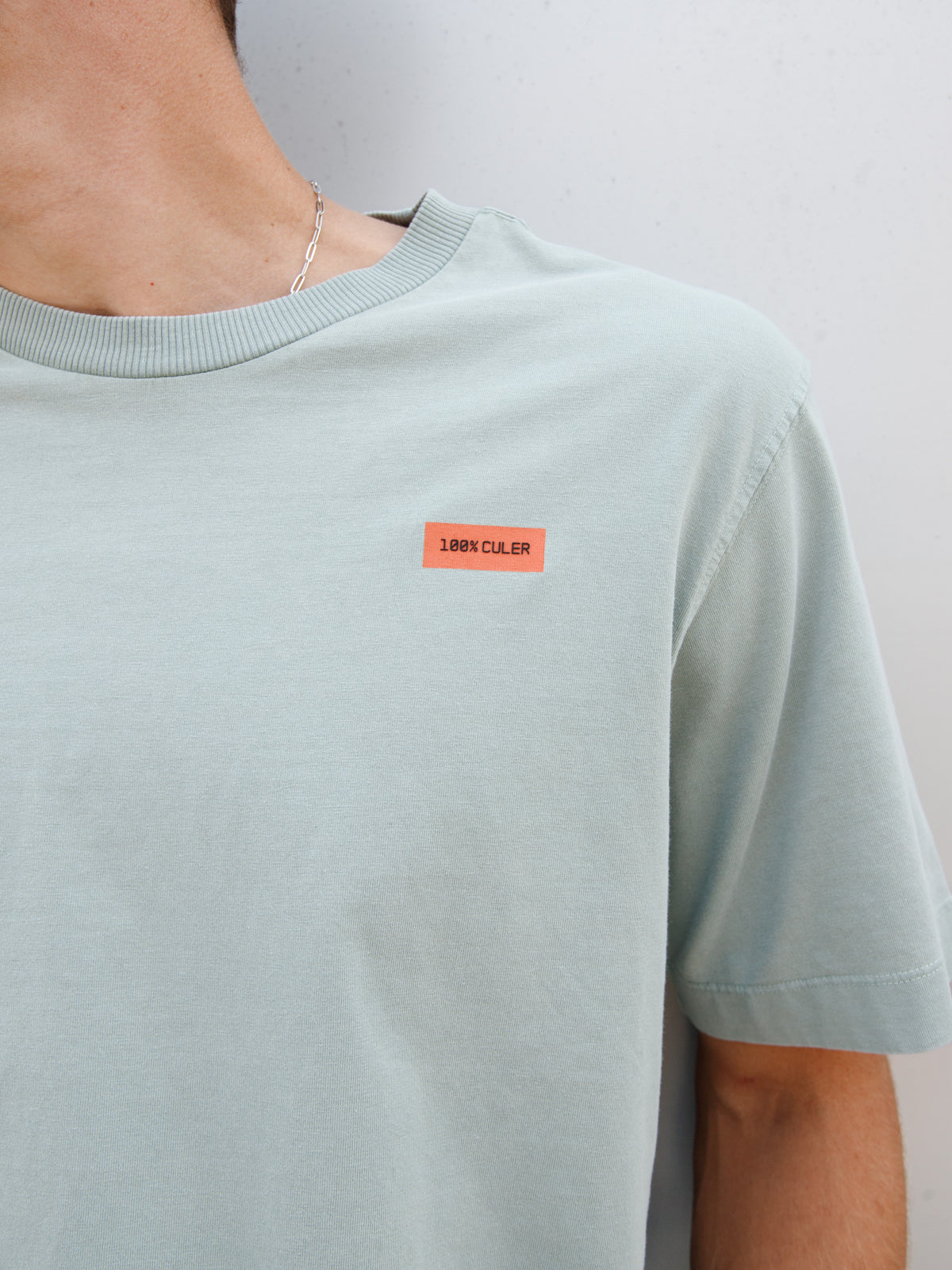 Christensen wearing a light green FC Barcelona T-shirt with tonal crest and 'Good Game Lover’s Crew' graphic print on the back