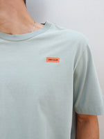 Christensen wearing a light green FC Barcelona T-shirt with tonal crest and 'Good Game Lover’s Crew' graphic print on the back