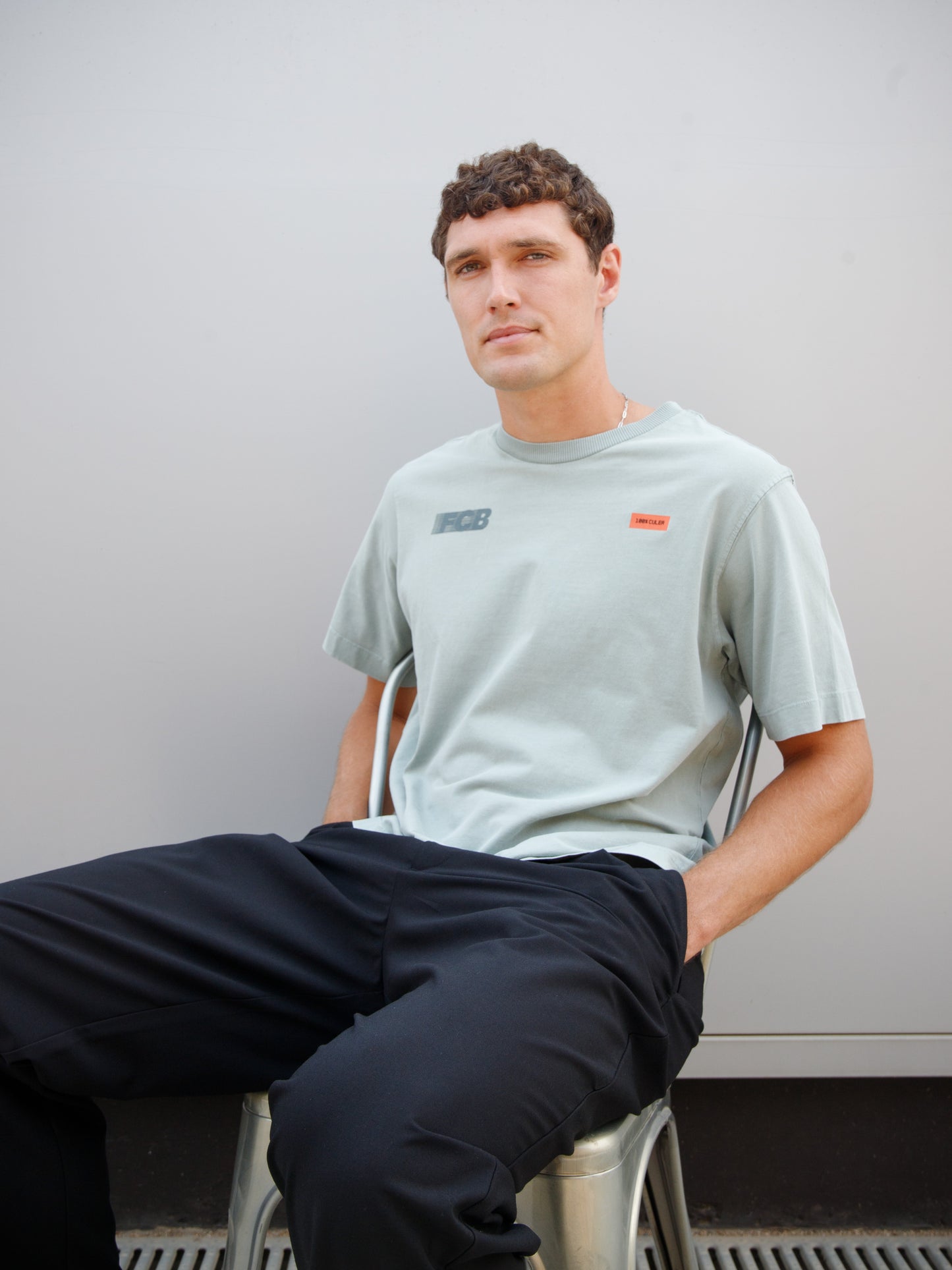 Christensen wearing a light green FC Barcelona T-shirt with tonal crest and 'Good Game Lover’s Crew' graphic print on the back