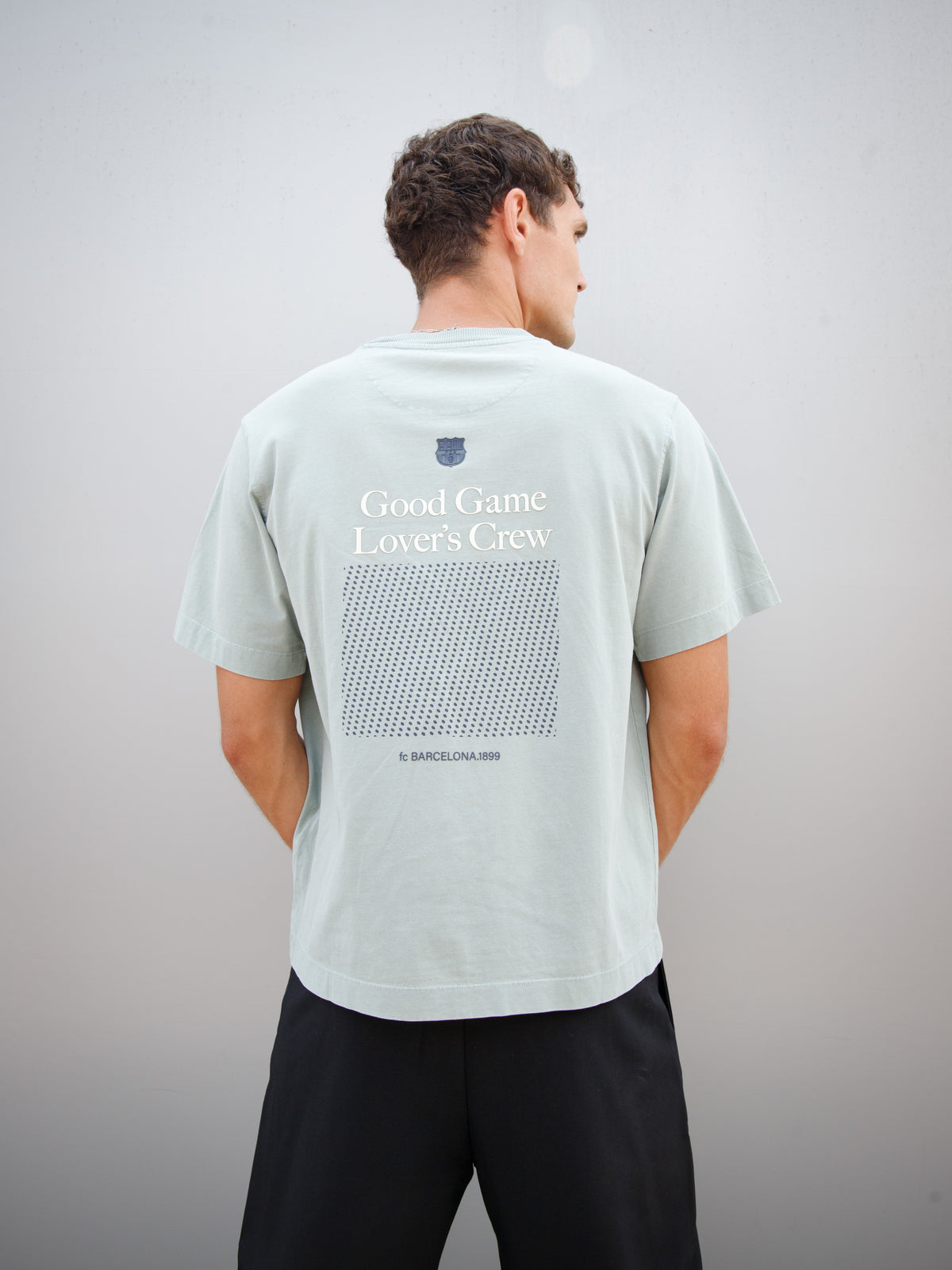 Christensen wearing a light green FC Barcelona T-shirt with tonal crest and 'Good Game Lover’s Crew' graphic print on the back