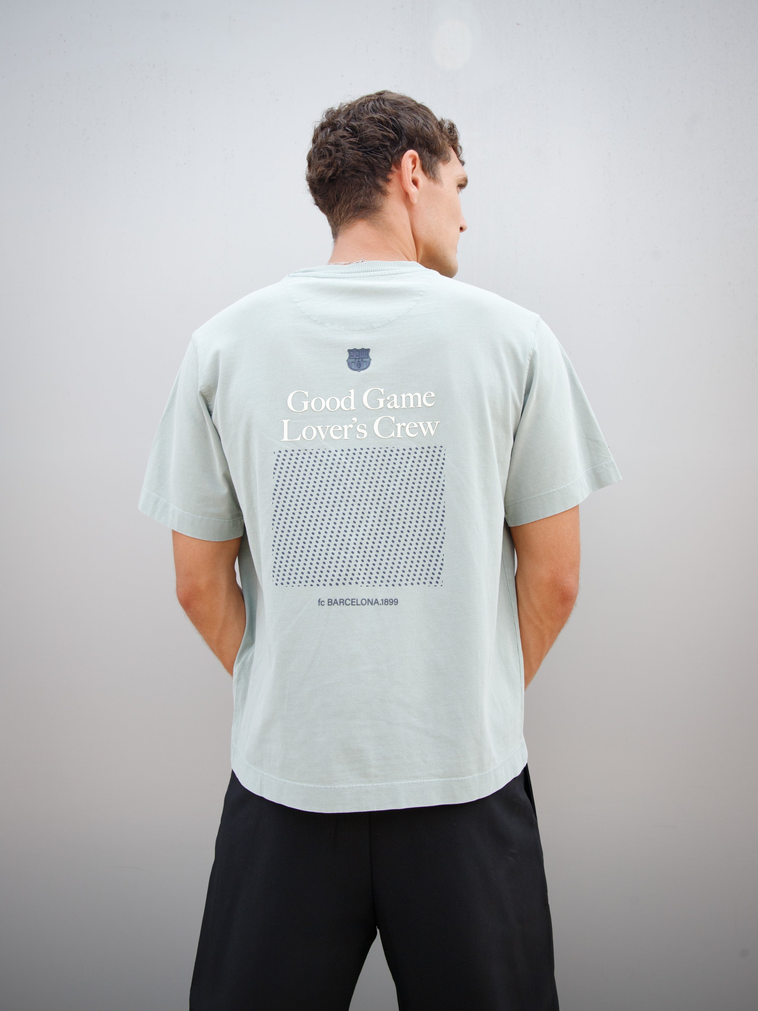 Christensen wearing a light green FC Barcelona T-shirt with tonal crest and 'Good Game Lover’s Crew' graphic print on the back
