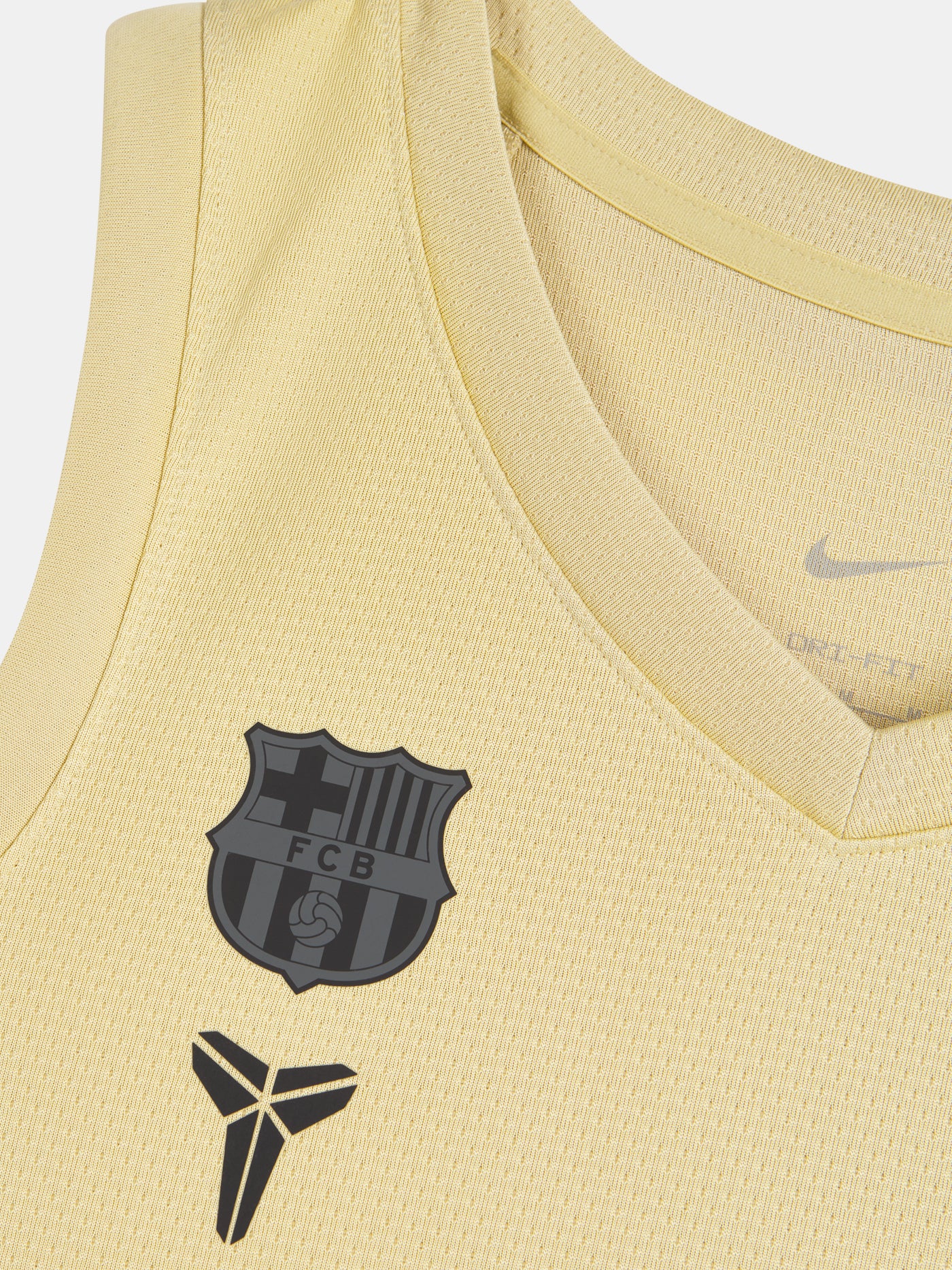 FC Barcelona gold basketball uniform with Assitència Sanitària sponsor, standing in white sneakers