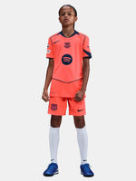 FC Barcelona 2025 third kit football jersey in orange with navy blue details, featuring Spotify sponsor logo and Nike branding.