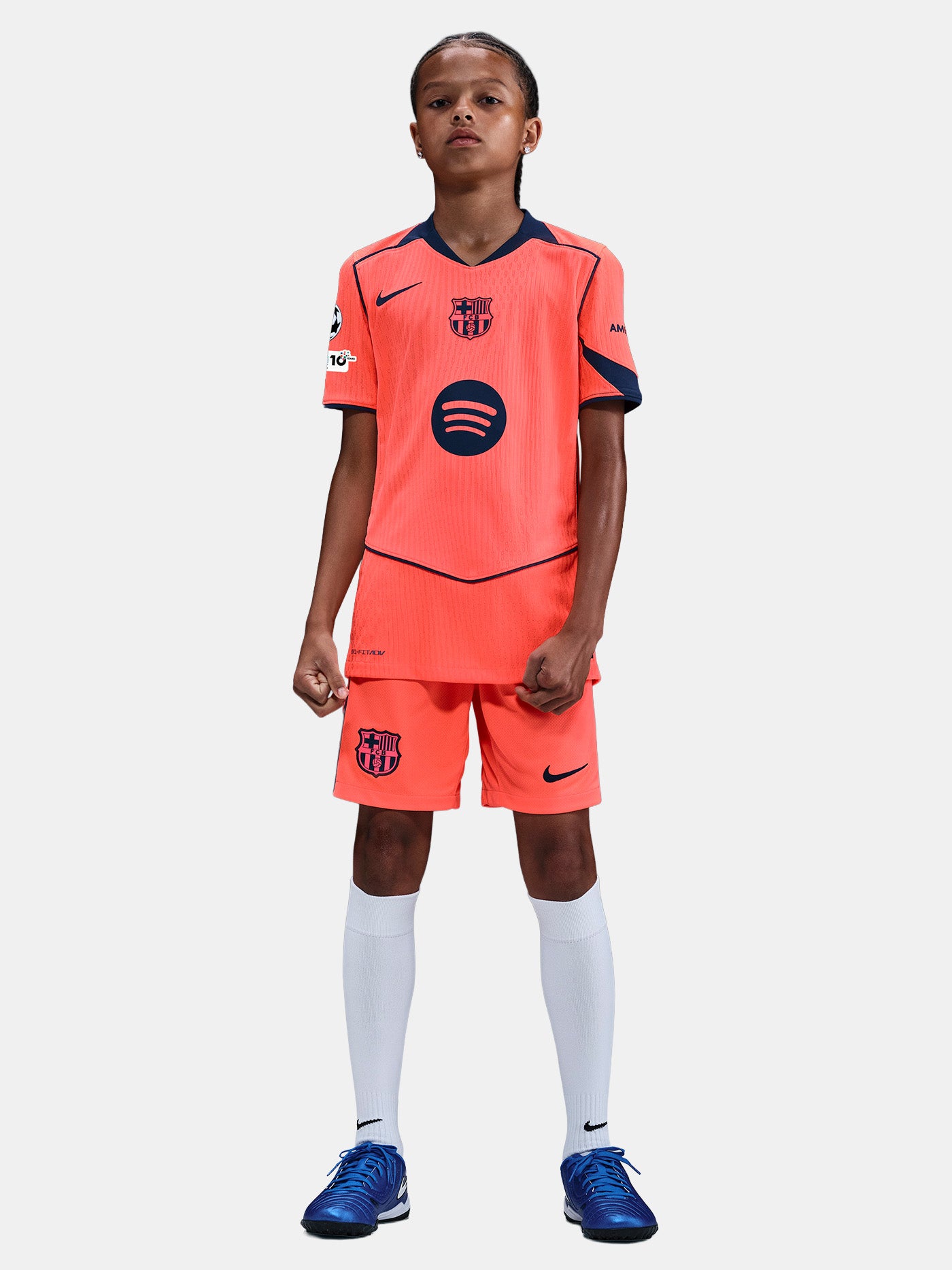 FC Barcelona third kit football jersey in orange with navy blue details, featuring Spotify sponsor logo and Nike branding.