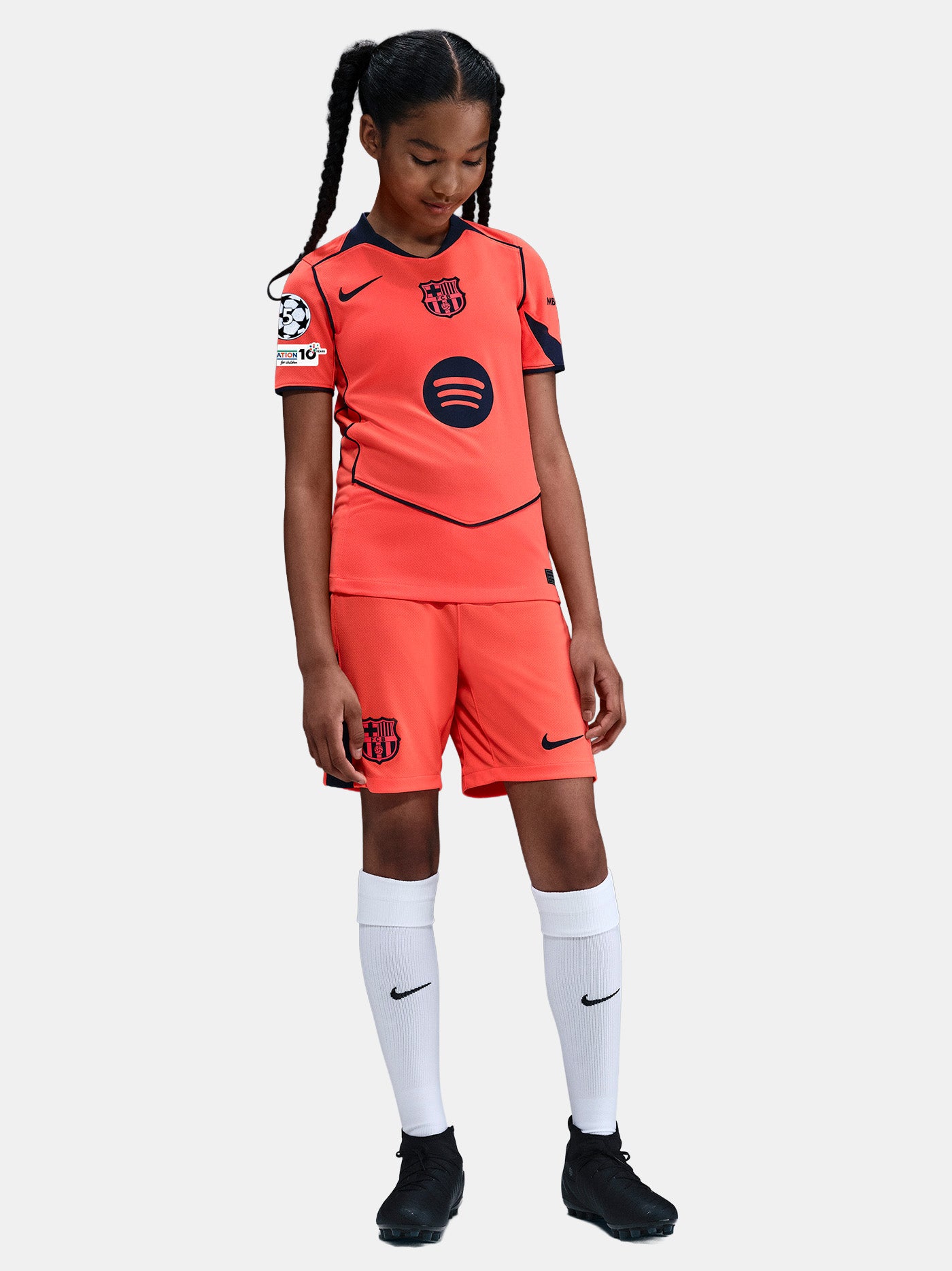 FC Barcelona third kit football jersey in orange with navy blue details, featuring Spotify sponsor logo and Nike branding.