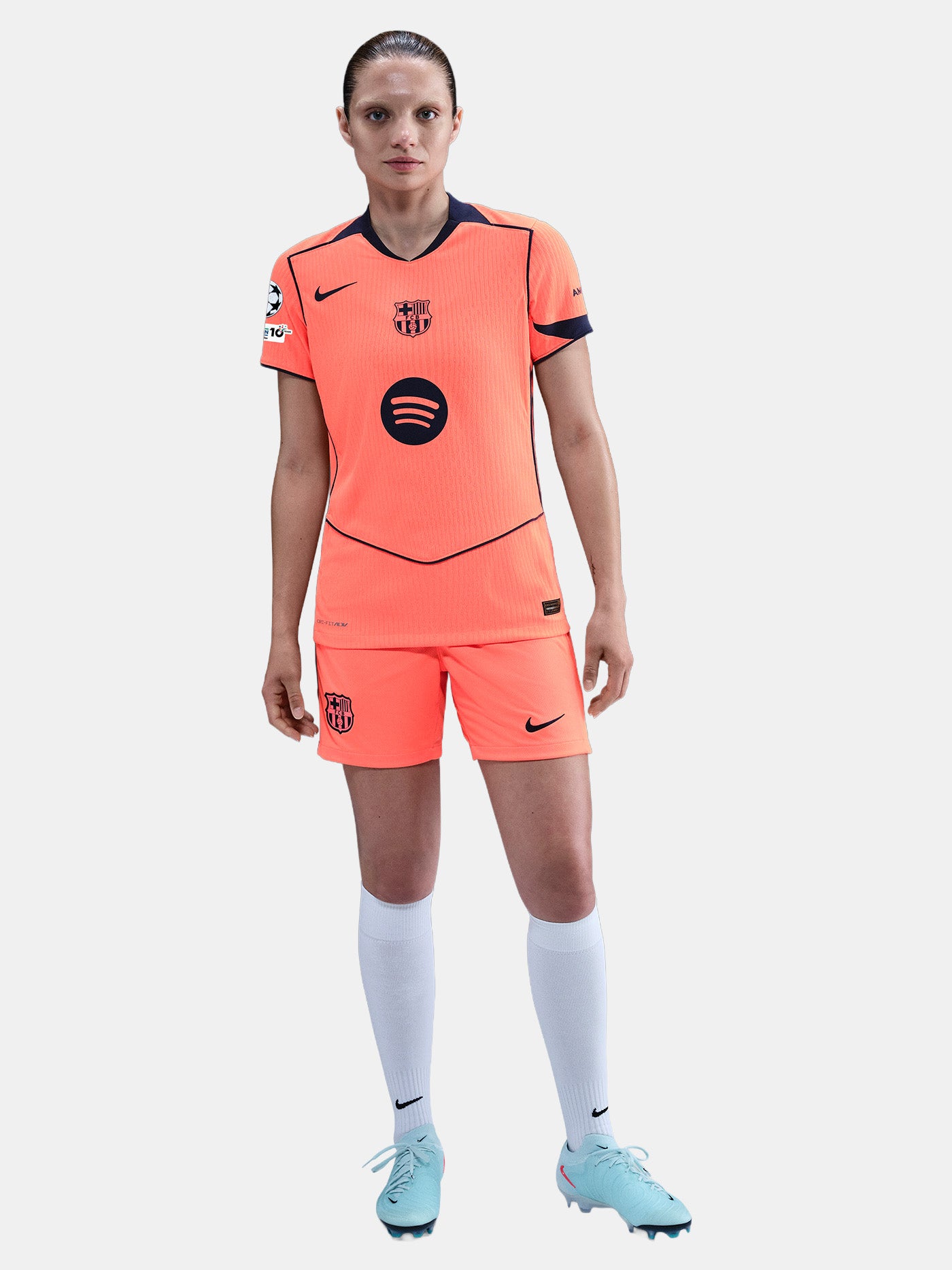 FC Barcelona third kit football jersey in orange with navy blue details, featuring Spotify sponsor logo and Nike branding.