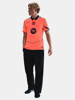 FC Barcelona third kit football jersey in orange with navy blue details, featuring Spotify sponsor logo and Nike branding.