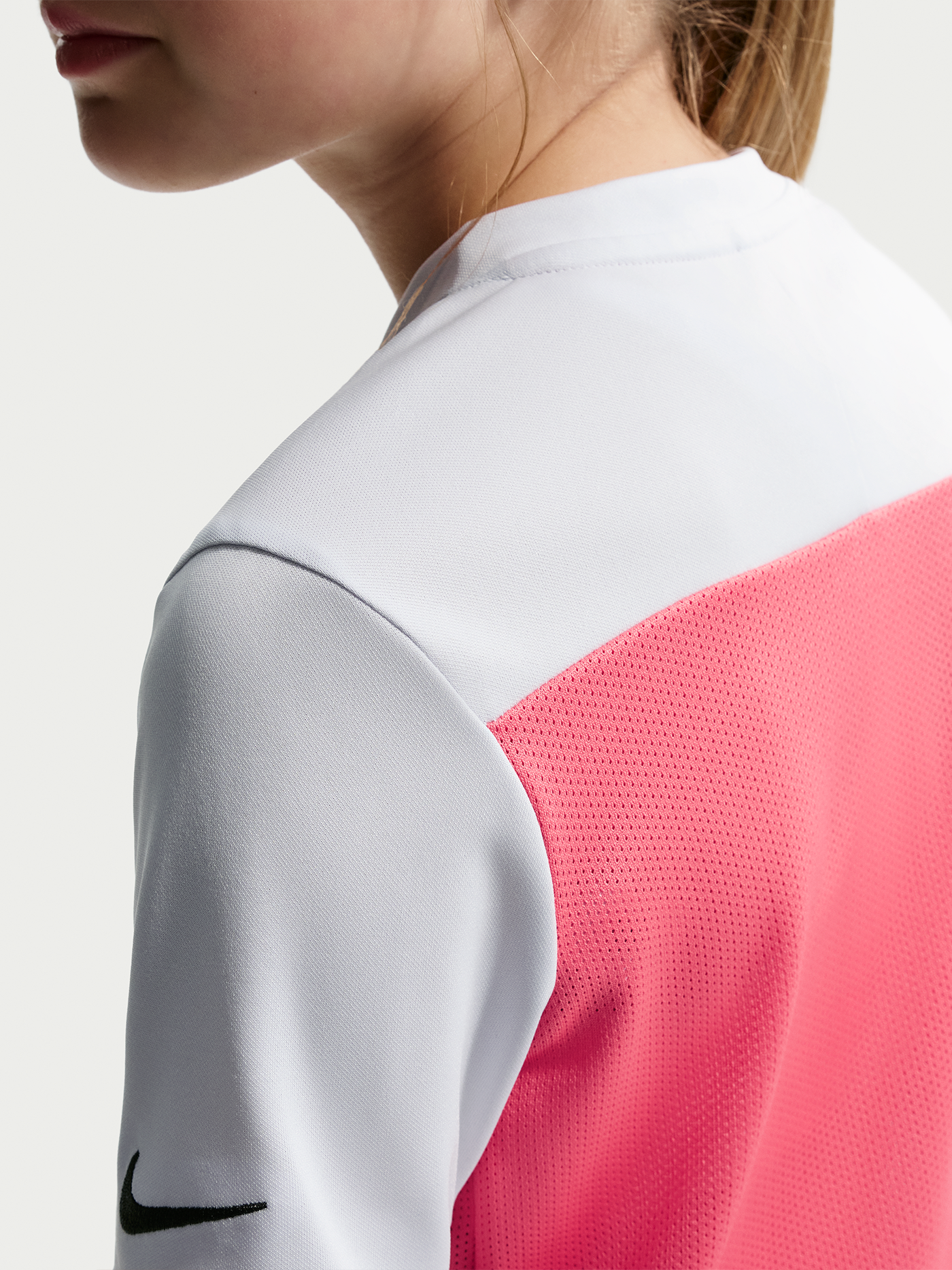 Person wearing a sports jersey with a Nike logo on a white background