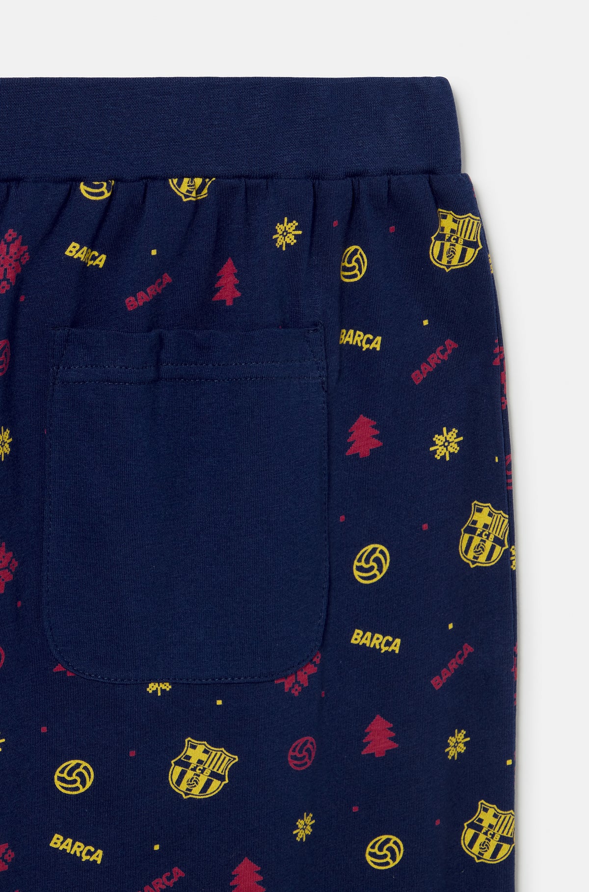 Close-up of navy FC Barcelona joggers with a back pocket and an allover Barça crest and winter-themed print.