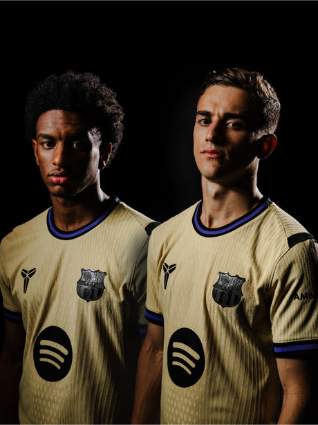 Balde and Gavi  are wearing matching Away jerseys with logos on a black background