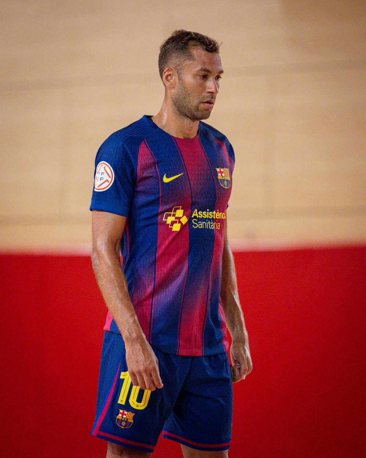 Man in FC Barcelona futsal kit with red and blue vertical stripes and number 10 on shorts