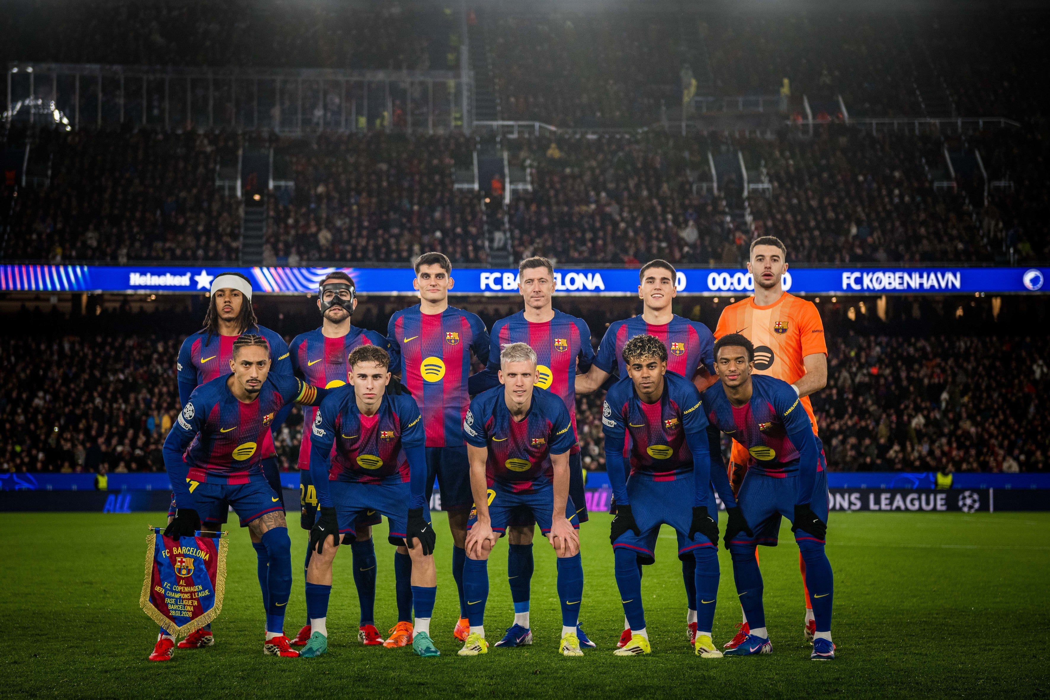 Soccer team lineup on the field with stadium lights in the background