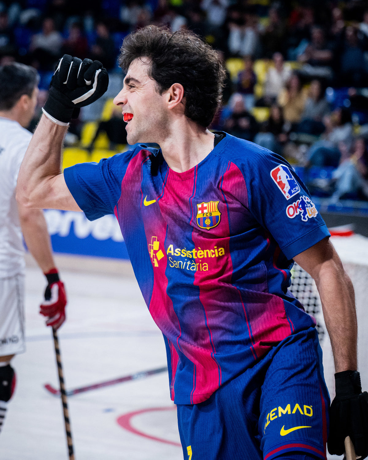 Person wearing a colorful sports jersey with visible branding in an indoor sports arena.