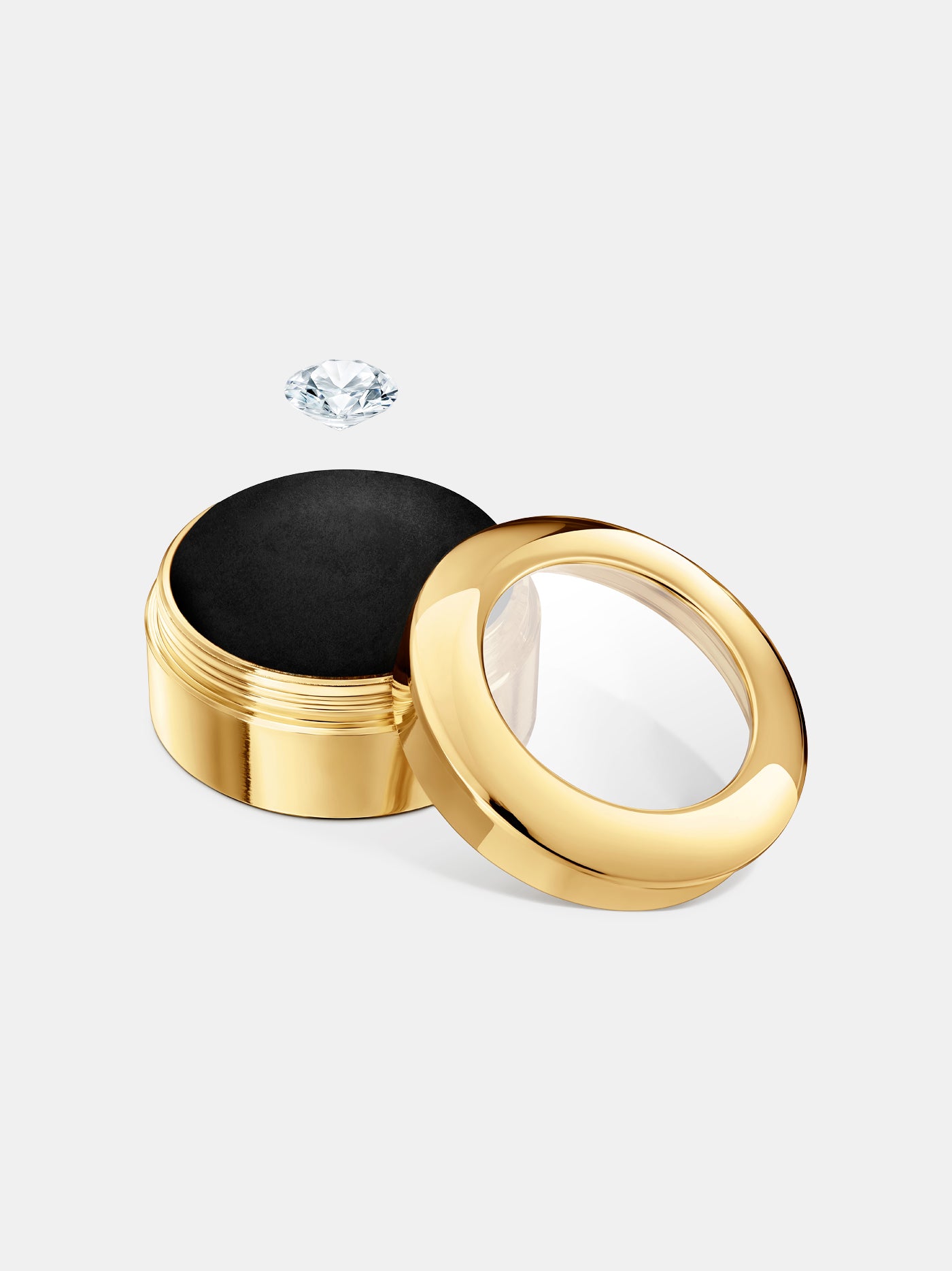 Elegant round gold display case with a transparent lid and black interior cushion, designed to showcase a collectible item.

