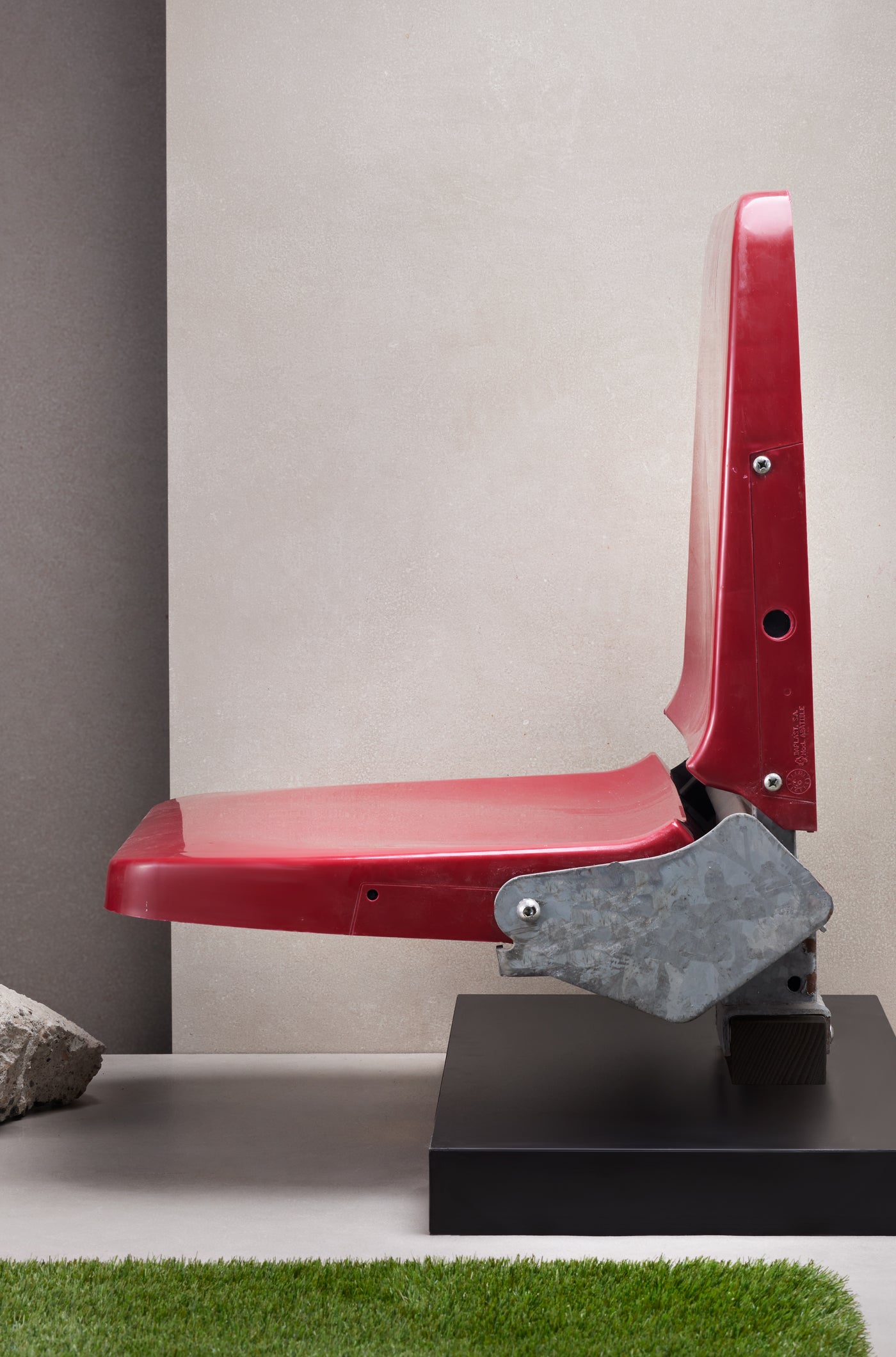 Original red stadium seat from Spotify Camp Nou mounted on a black display base with commemorative plaque.
