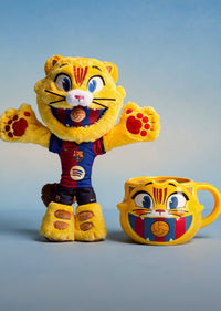 Plush toy and mug with a cartoon tiger design on a blue background