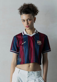 Person wearing a Barcelona football jersey against a plain background