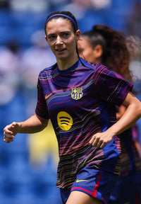 Woman wearing a sports jersey with a logo on a blurred background