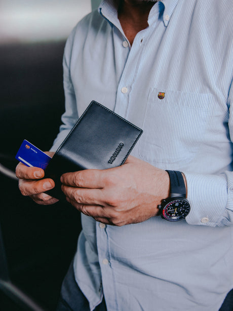 Close-up of a black leather wallet with an embossed FC Barcelona logo on the corner.