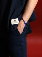 Braided bracelet in classic FC Barcelona colors—deep blue and vibrant red—featuring a subtle yet bold contrast that reflects the club’s identity. The design includes a small clasp or knot detail in the center, reinforcing the sporty and casual aesthetic. It's a minimal but expressive accessory, perfect for fans who want to wear their passion in a subtle, stylish way.
