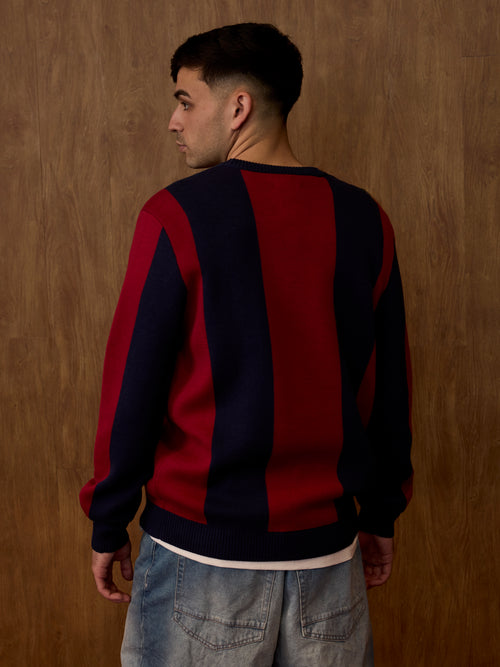 Back view of a model wearing a red and dark navy striped FC Barcelona sweater.