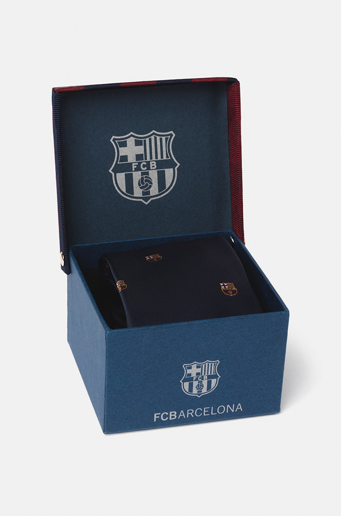 Navy blue tie featuring a repeating pattern of the FC Barcelona crest embroidered throughout the fabric.

