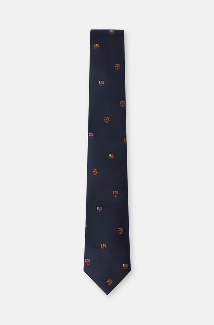 Navy blue tie featuring a repeating pattern of the FC Barcelona crest embroidered throughout the fabric.
